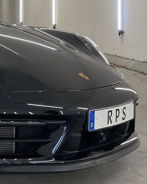 Front of a black Porsche 911 with an RPS number plate